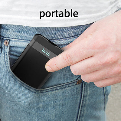 Closed black portable cable box being placed into a jeans pocket