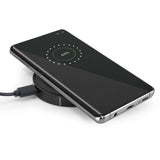 Orbit Wireless Charger charging smartphone with LED indicator showing battery level.