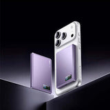 Remax FP-37 Magnetic Suction Wireless Charging Powerbank next to smartphone on a sleek black background.