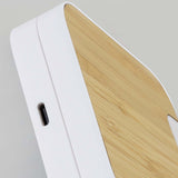 Close-up of the Flex Wireless Fast Charging Stand featuring a natural bamboo panel and sleek design.