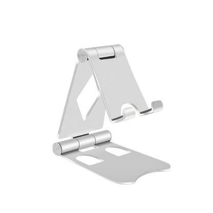 Silver-coloured foldable aluminium mobile stand opened to show its hinged support and phone ledge