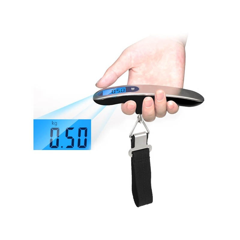 Digital luggage scale held in one hand with black hanging strap and metal clasp; enlarged display shows an example 0.50 kg reading