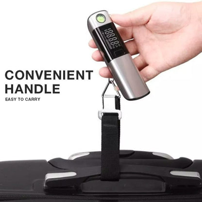 Hand holding the digital luggage scale with its black strap looped around a suitcase handle
