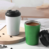 Stainless Steel 350ml Vacuum Mug in white and green on a wooden table with coffee beans.