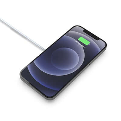 Phone illustration resting over the round wired magnetic wireless charging puck