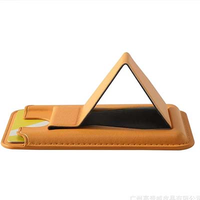 Brown phone stand and card holder opened into a triangular support beneath a phone