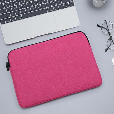 Pink padded laptop sleeve with dark edging and zip closure
