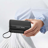 Remax RPP-E7 Fast Charging Powerbank with Wall Plug 27000mAh held in hand, showcasing sleek design and portability.