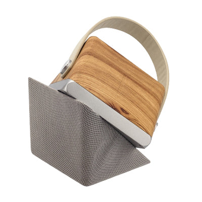 Speaker charger twisted open into an angled stand configuration with its wood-grain-finish panel raised