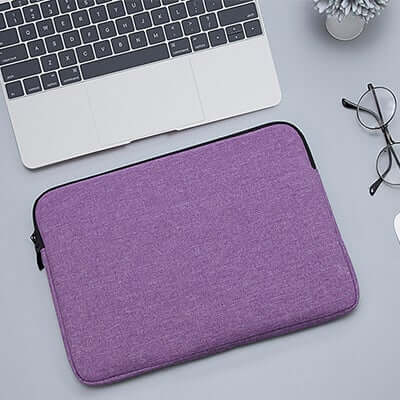 Purple padded laptop sleeve with dark edging and zip closure