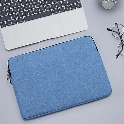 Blue padded laptop sleeve with dark edging and zip closure