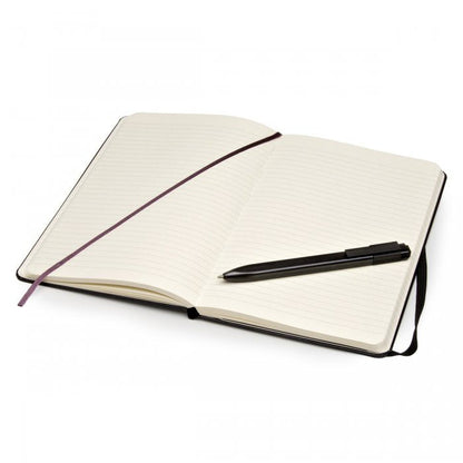 Open Moleskine ruled notebook with ribbon bookmark and black roller pen across the pages