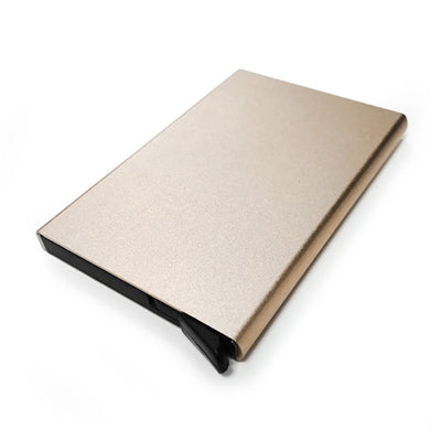 Gold-coloured metal card holder shown closed with a plain rectangular face