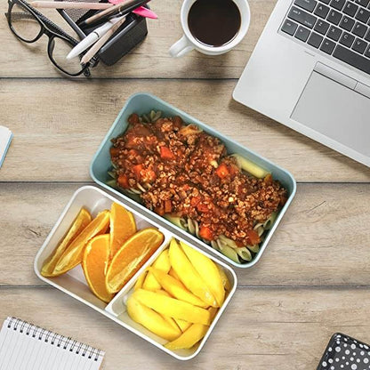 Open lunch box tiers illustrated with a meal beside a laptop and drink on a desk