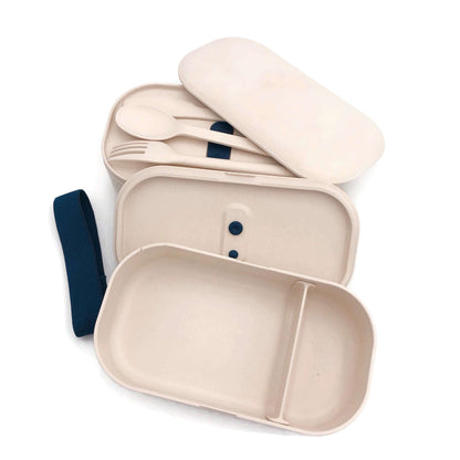 Angled view of beige two-tier lunch box with containers and covers separated