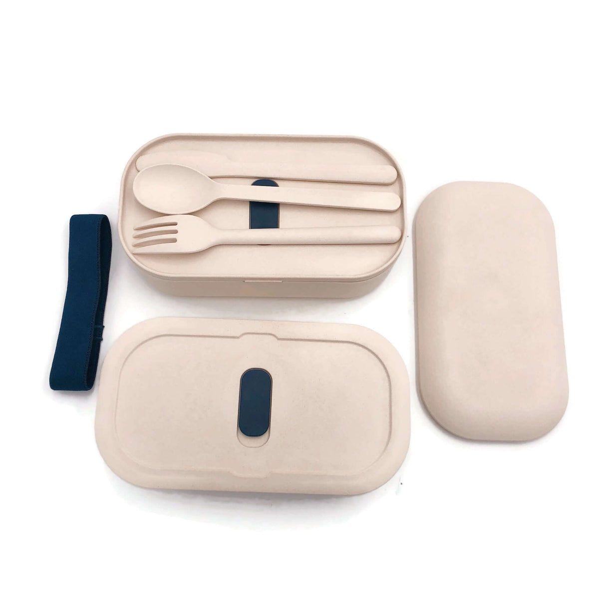 Two-tier lunch box viewed from above with outer lid removed and cutlery on an inner cover