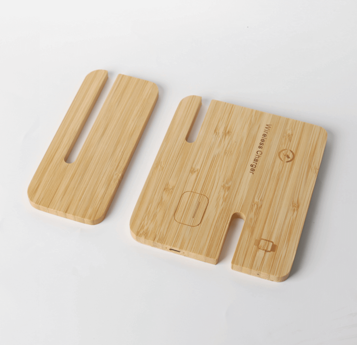 Two slotted bamboo charger sections laid flat, with phone, earbud-case and watch position symbols on the larger panel