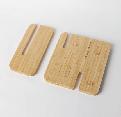 Two slotted bamboo charger sections laid flat, with phone, earbud-case and watch position symbols on the larger panel