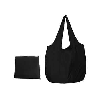 Black foldable nylon tote with carrying handles beside a matching square storage form