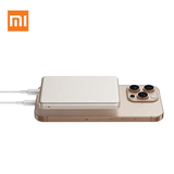 Xiaomi Super Slim Magnetic Power Bank 5000 charging a smartphone, showcasing its sleek design and efficiency.