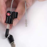 Crossing TSA Travel Cable Lock With Keys in a hand, showcasing a durable design and security features.
