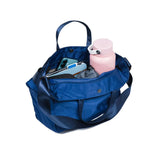 Crossing Hollis Anti-Theft RFID Dual Carry Crossbody Bag in blue color with phone and water bottle inside.