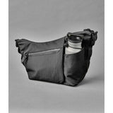 ALPAKA Flow Satchel Sling Bag with integrated bottle sleeve for hydration and organized storage