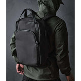 ALPAKA Bravo Tote Pack being worn by a person with a black backpack, showcasing its sleek design and versatility.