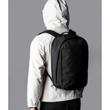 ALPAKA Metro Backpack Pro worn by a person in a light jacket, showcasing its sleek design and functionality.