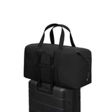 Gaston Luga Dash Weekender 2.0 Large stylishly placed on top of a suitcase, ideal for corporate gifts.