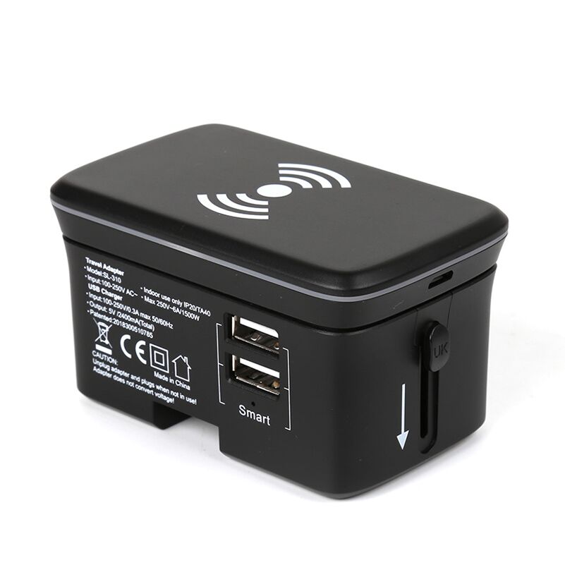 Assembled black travel adaptor with the wireless charging pad on top, two USB-A ports and a side plug-selector slider