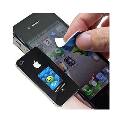 Hand using a small sticky screen cleaner on a phone screen beside a printed cleaner attached to a phone
