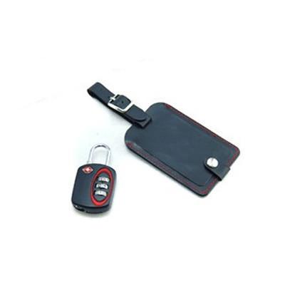 Black combination padlock with red dial surround beside a black luggage tag with red stitching and buckled strap