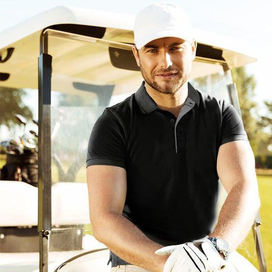Model wearing a black UNO Aero short-sleeve polo outdoors beside a golf cart